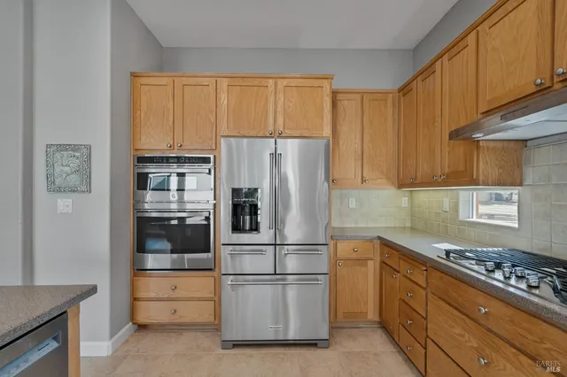 a spacious bedroom with a large bed and a chandelier