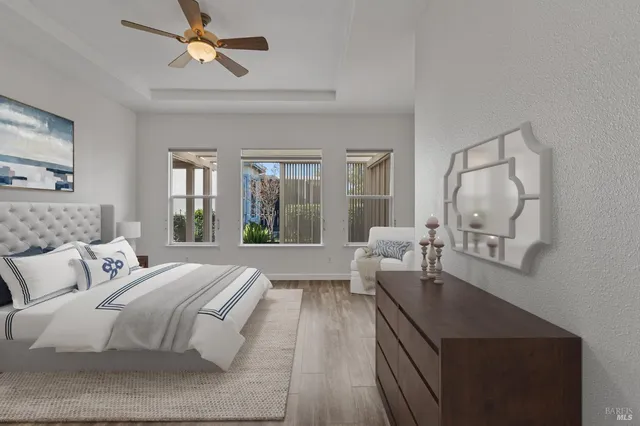 a spacious bedroom with a bed and painting on the wall