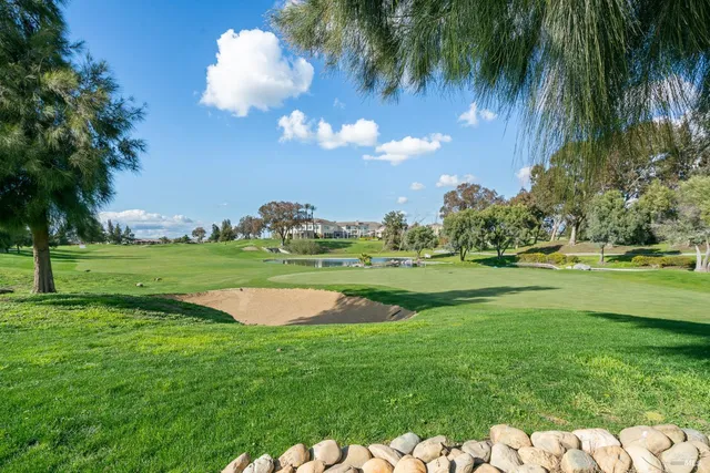 a view of swimming pool is middle in the garden