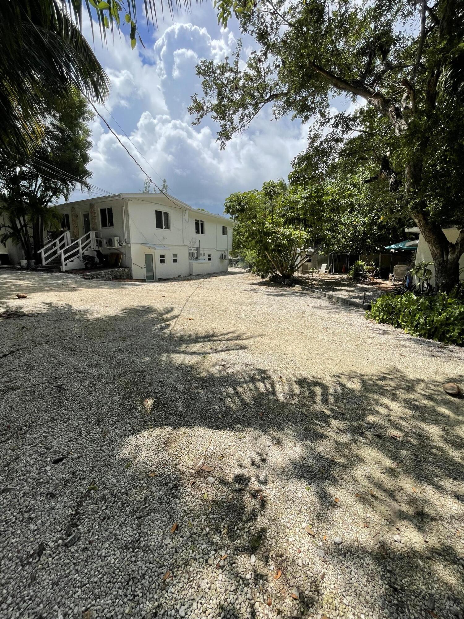 a view of a yard with cars parked