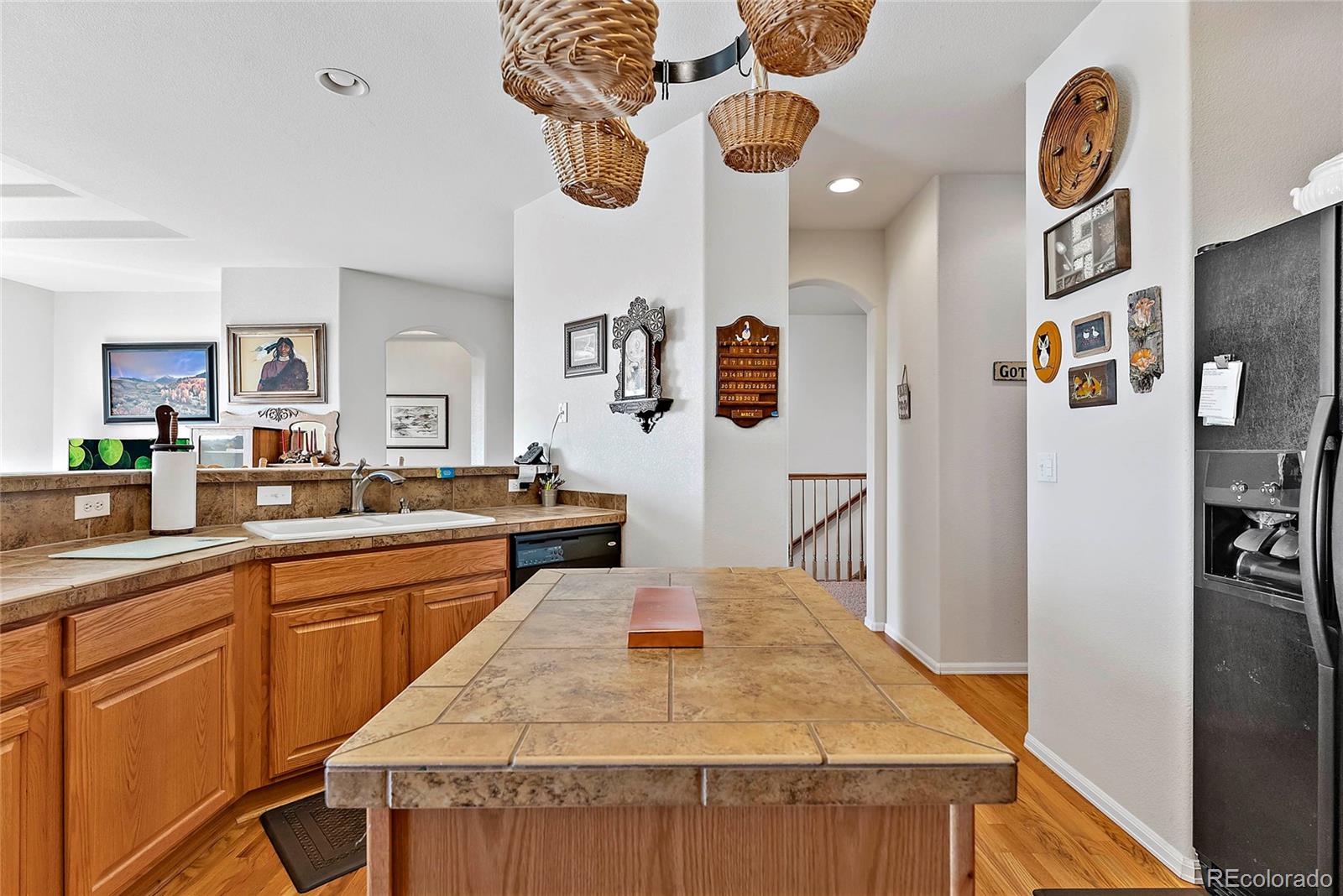 8006 Raspberry Drive Frederick, CO 80504 - Photo 11 of 27 a kitchen with stainless steel appliances granite countertop a sink and a refrigerator