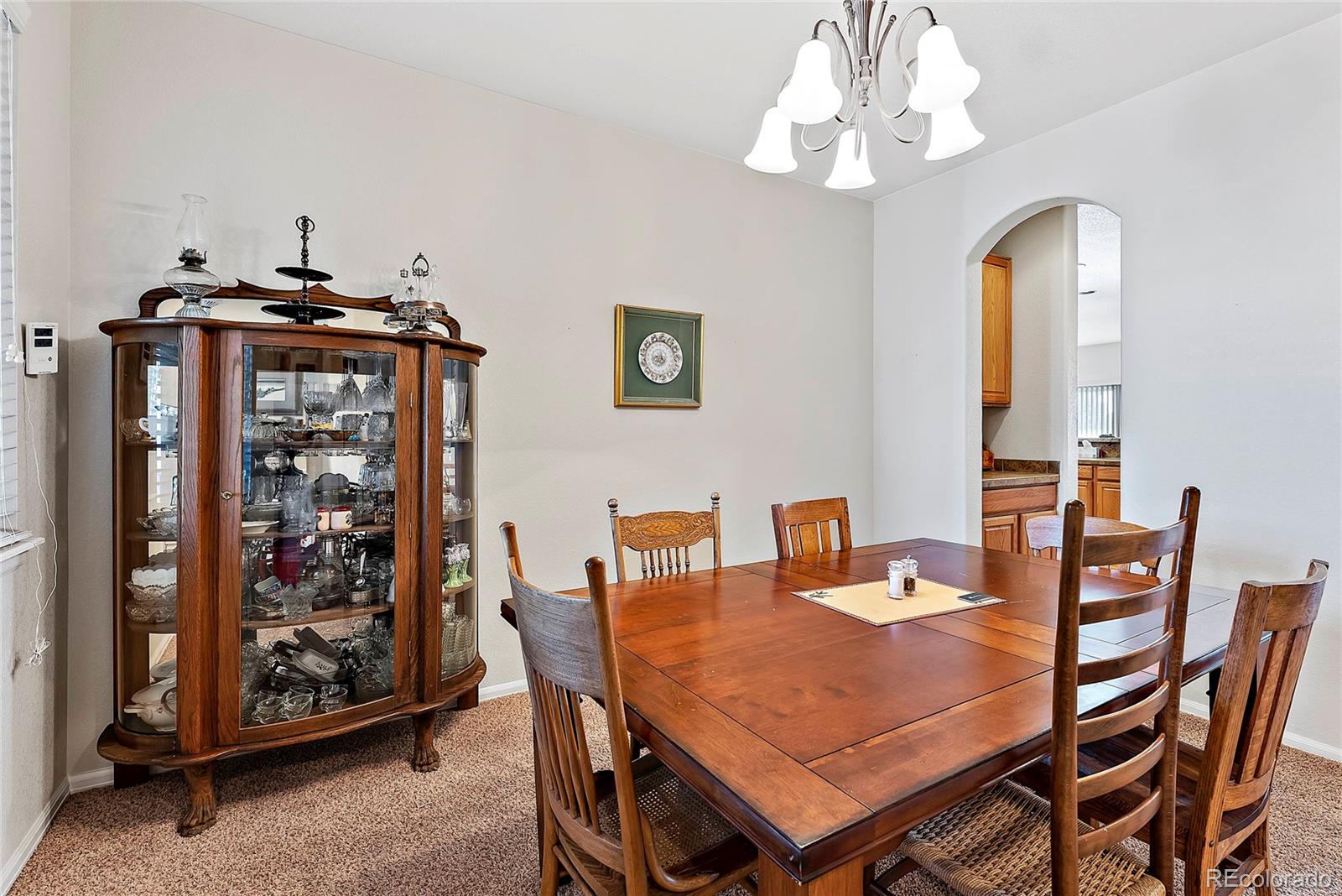 8006 Raspberry Drive Frederick, CO 80504 - Photo 13 of 27 a view of a dining room with furniture and chandelier