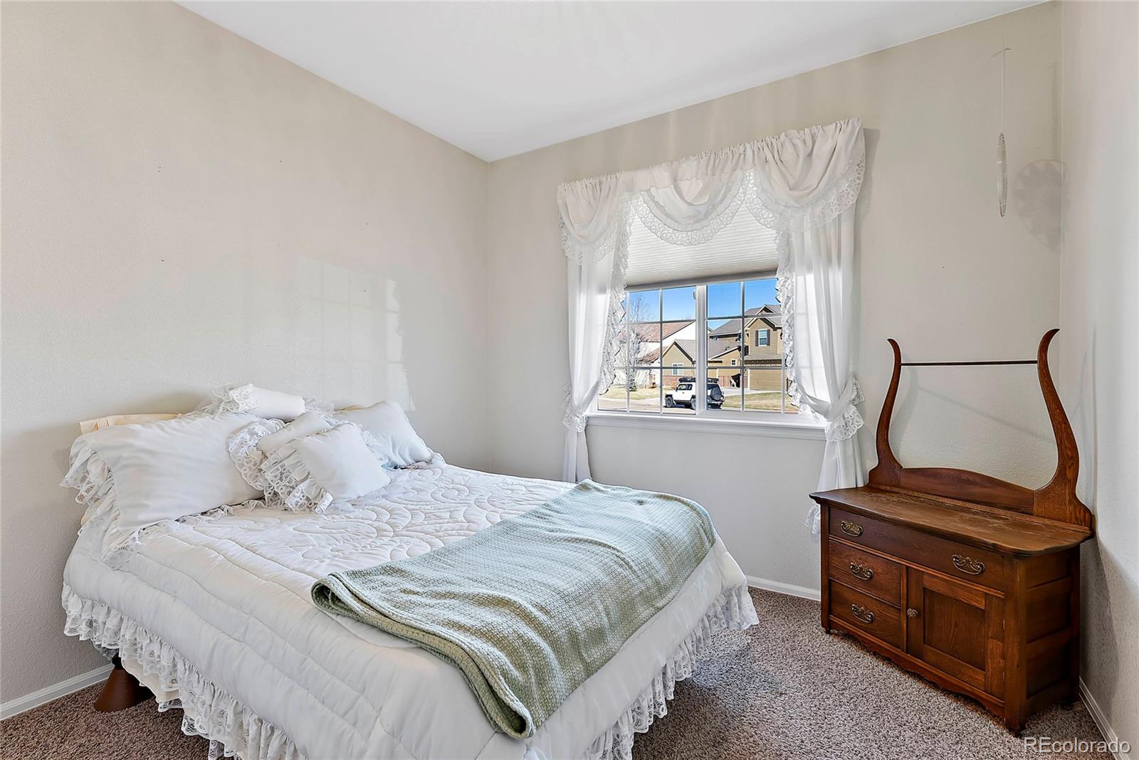 8006 Raspberry Drive Frederick, CO 80504 - Photo 19 of 27 a bedroom with a bed and a dresser