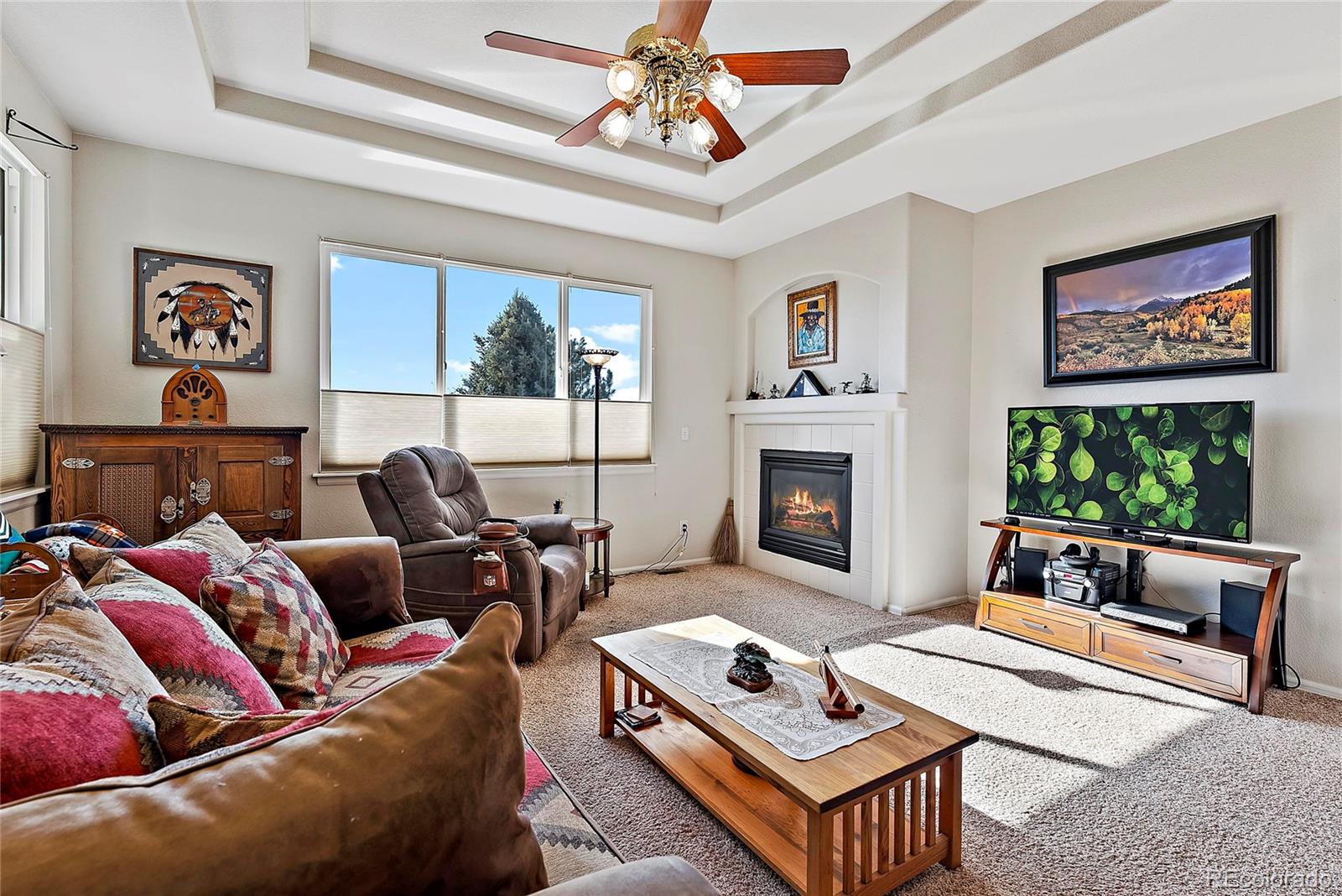 8006 Raspberry Drive Frederick, CO 80504 - Photo 2 of 27 a living room with furniture a flat screen tv and a fireplace