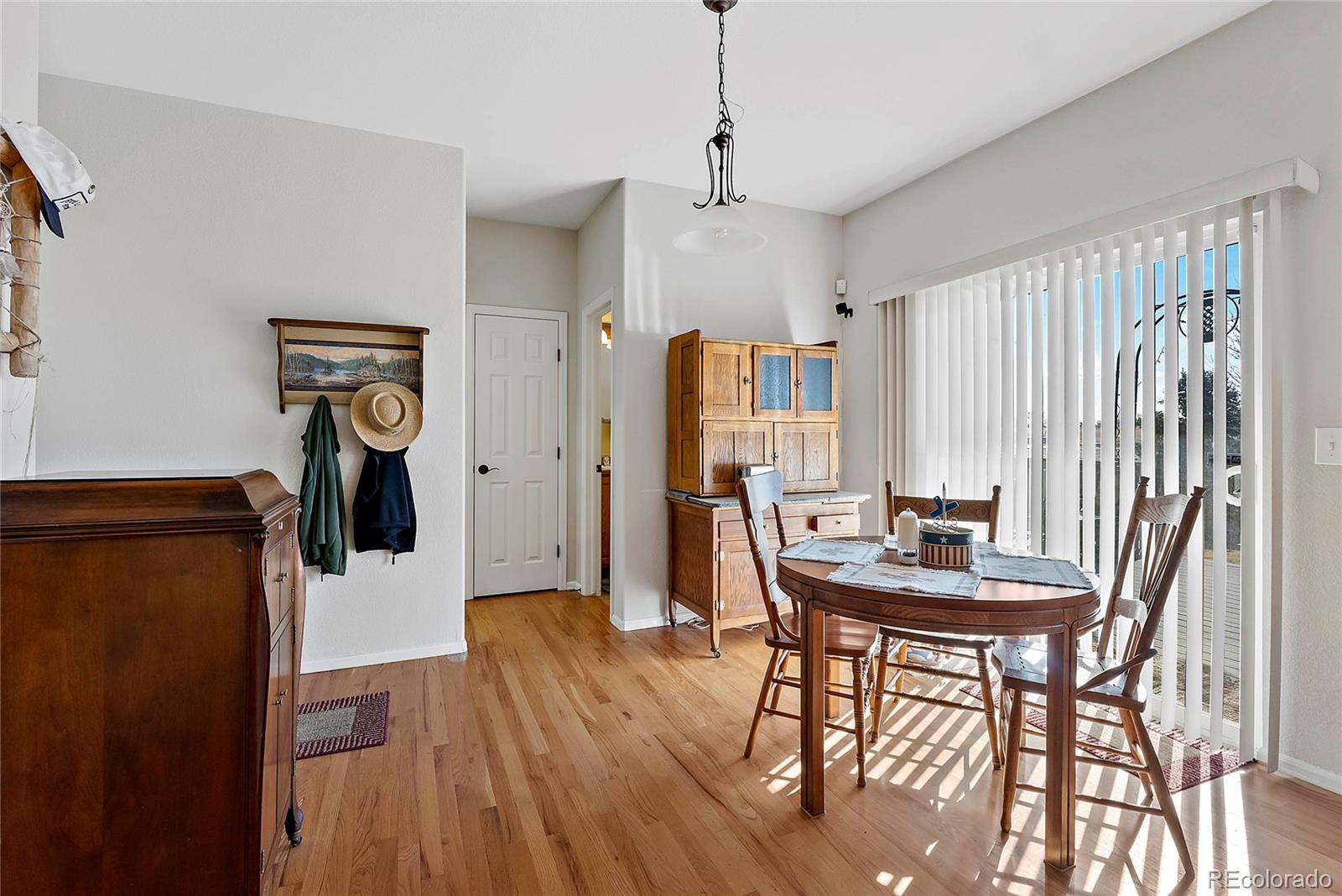 8006 Raspberry Drive Frederick, CO 80504 - Photo 7 of 27 a view of a dining room with furniture and wooden floor