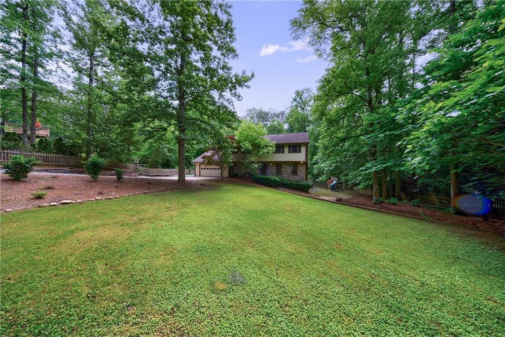 10565 Shallowford Road Roswell, GA 30075 - Photo 2 of 18 a view of a backyard with swimming pool