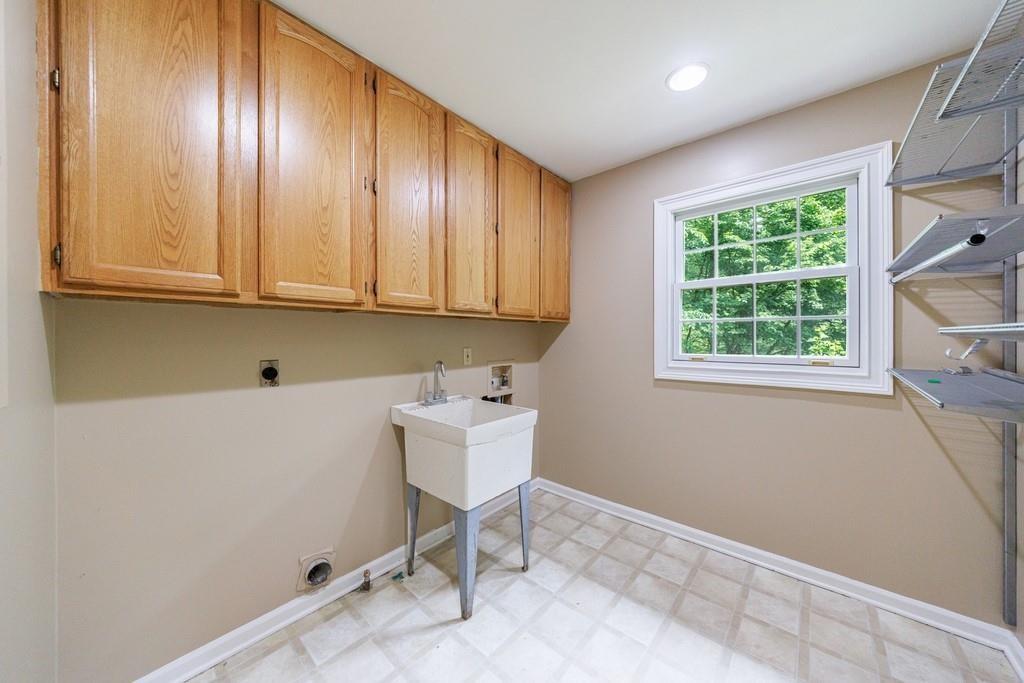 10565 Shallowford Road Roswell, GA 30075 - Photo 9 of 18 a room with a window closet and wooden floor