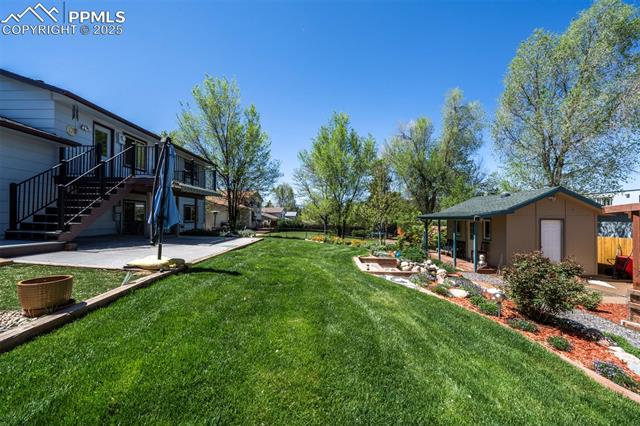 3870 Half Turn Road Colorado Springs, CO 80917 - Photo 8 of 34 View of yard featuring a patio area and stairway