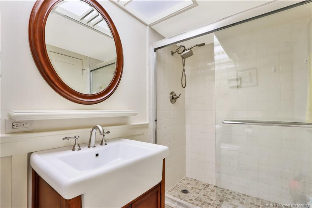 1862 Southwest Palm City Road, Unit 202 Stuart, FL 34994 - Photo 14 of 15 a bathroom with a sink and a mirror