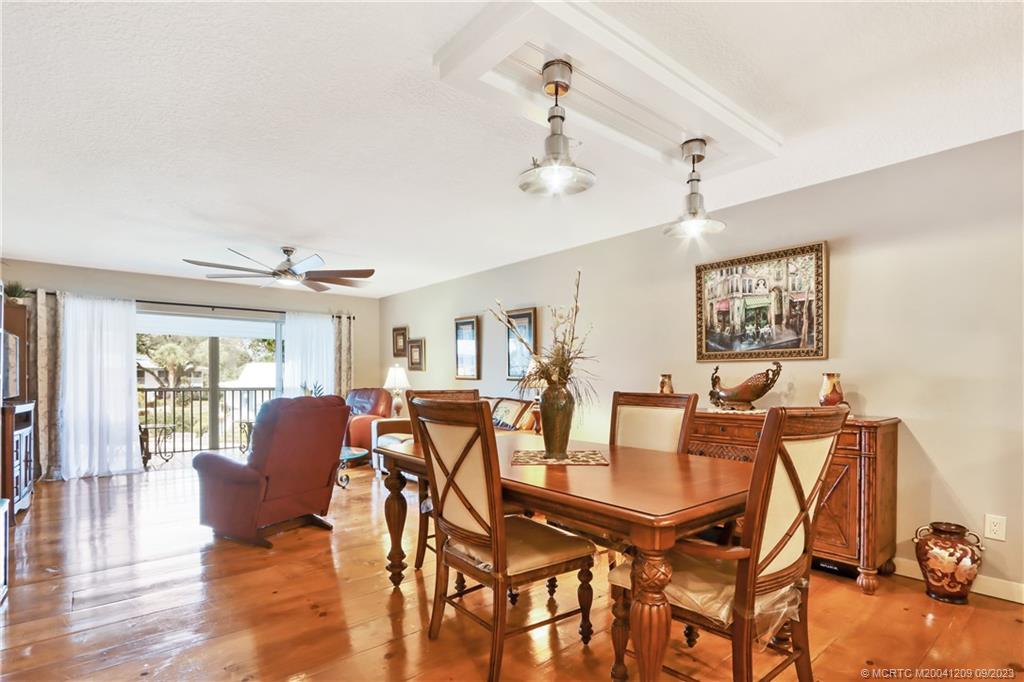 1862 Southwest Palm City Road, Unit 202 Stuart, FL 34994 - Photo 7 of 15 a view of a dining room with furniture window and wooden floor