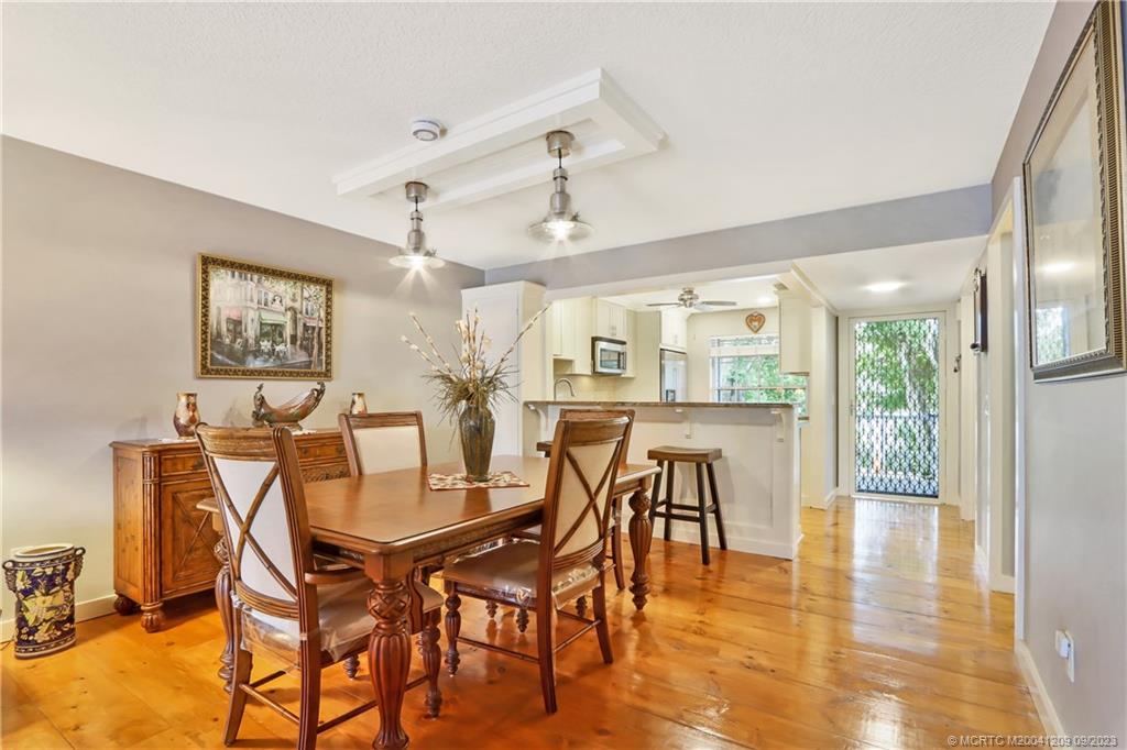 1862 Southwest Palm City Road, Unit 202 Stuart, FL 34994 - Photo 10 of 15 a view of a dining room with furniture and wooden floor