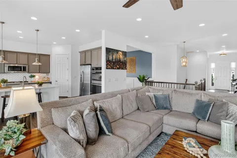 a living room with furniture and kitchen view