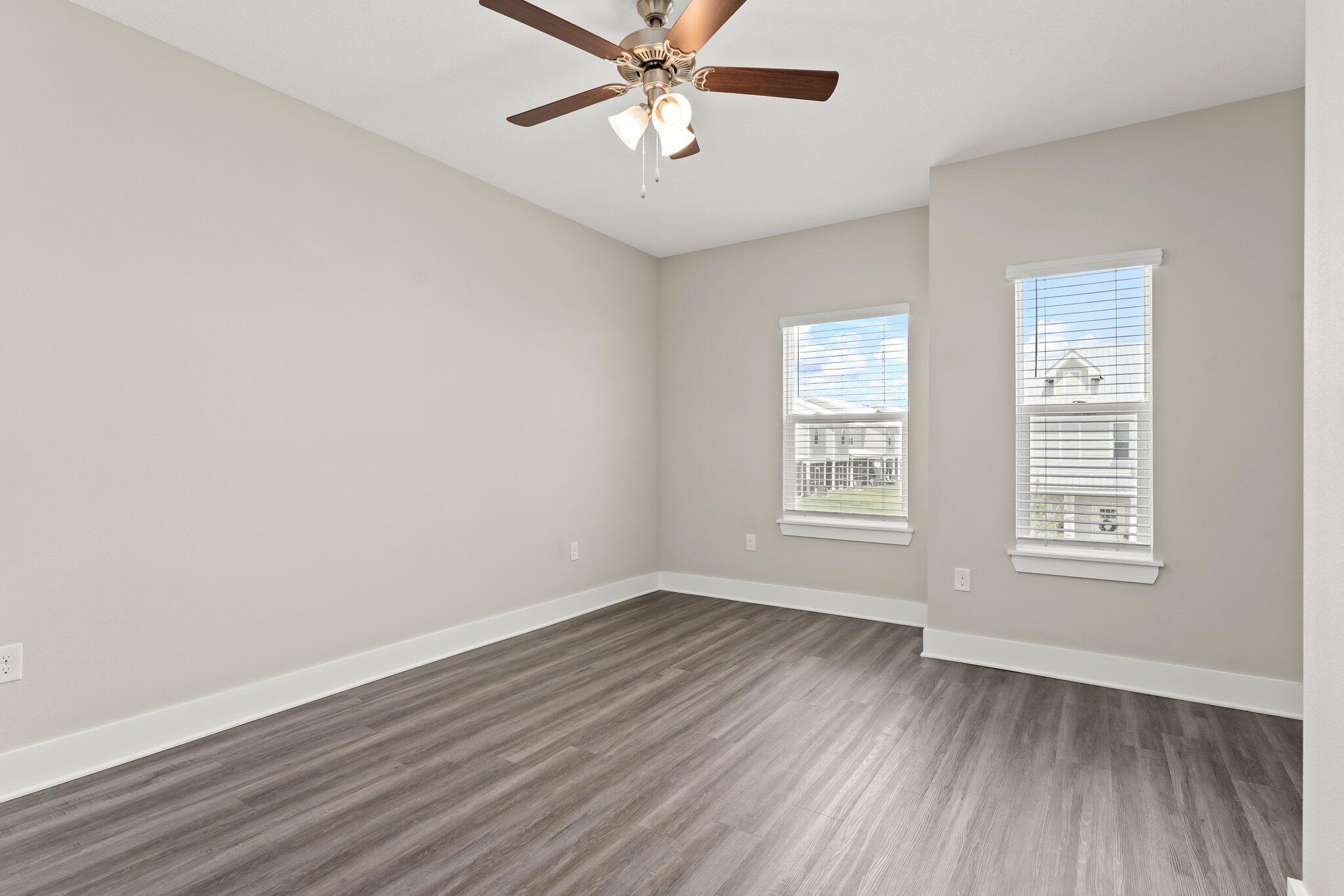 352 North Sand Palm Road, Unit VISTA Freeport, FL 32439 - Photo 15 of 29 a view of an empty room with wooden floor and a window