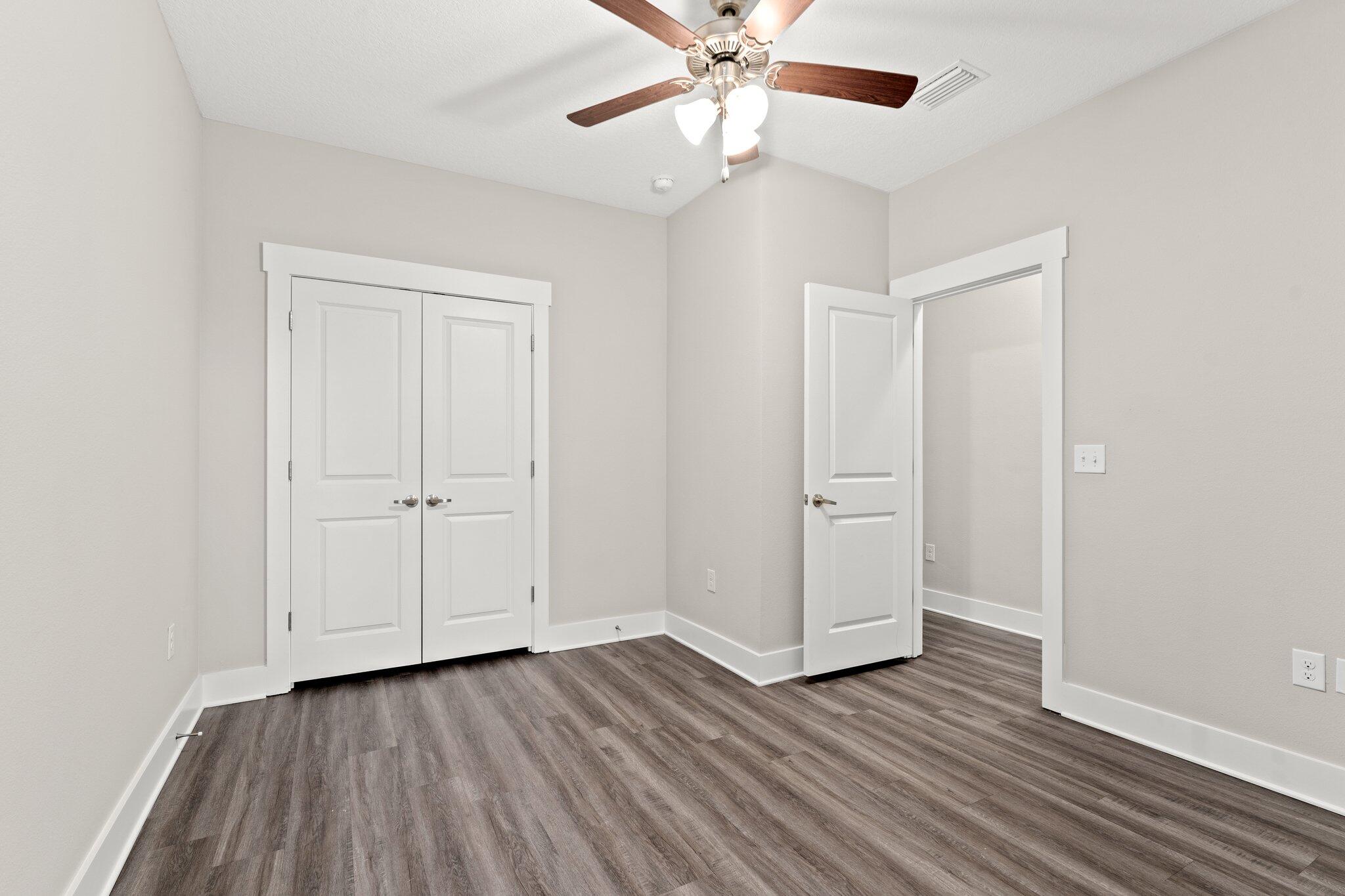 352 North Sand Palm Road, Unit VISTA Freeport, FL 32439 - Photo 22 of 29 an empty room with wooden floor closet and windows