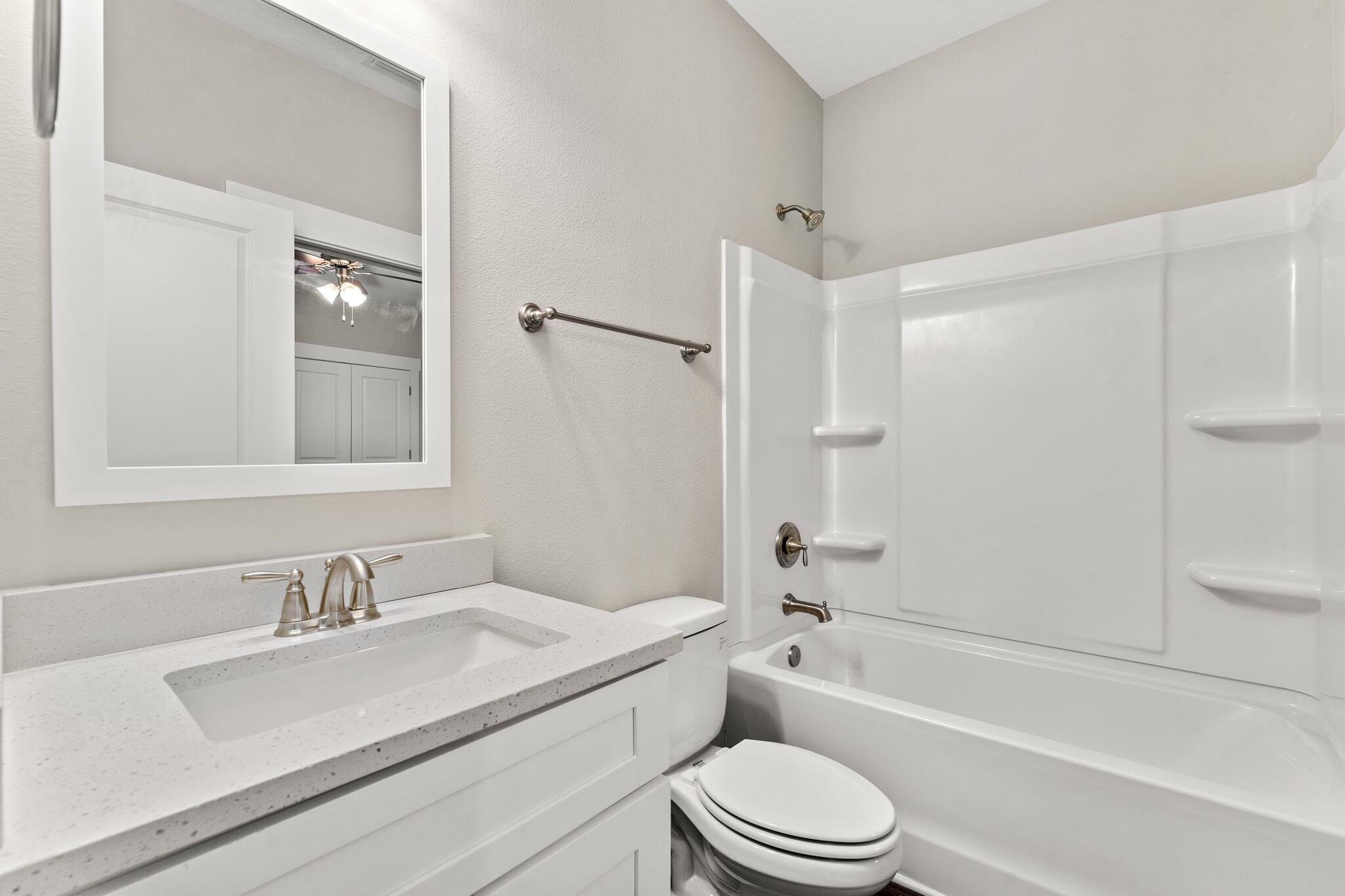 352 North Sand Palm Road, Unit VISTA Freeport, FL 32439 - Photo 23 of 29 a bathroom with a granite countertop sink toilet and shower