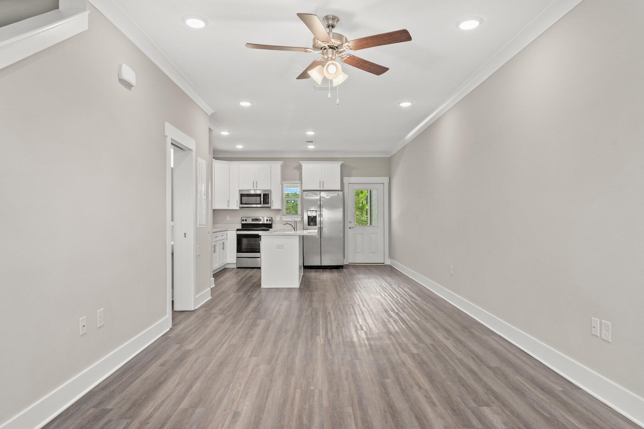 352 North Sand Palm Road, Unit VISTA Freeport, FL 32439 - Photo 3 of 29 a view of kitchen with wooden floor and window