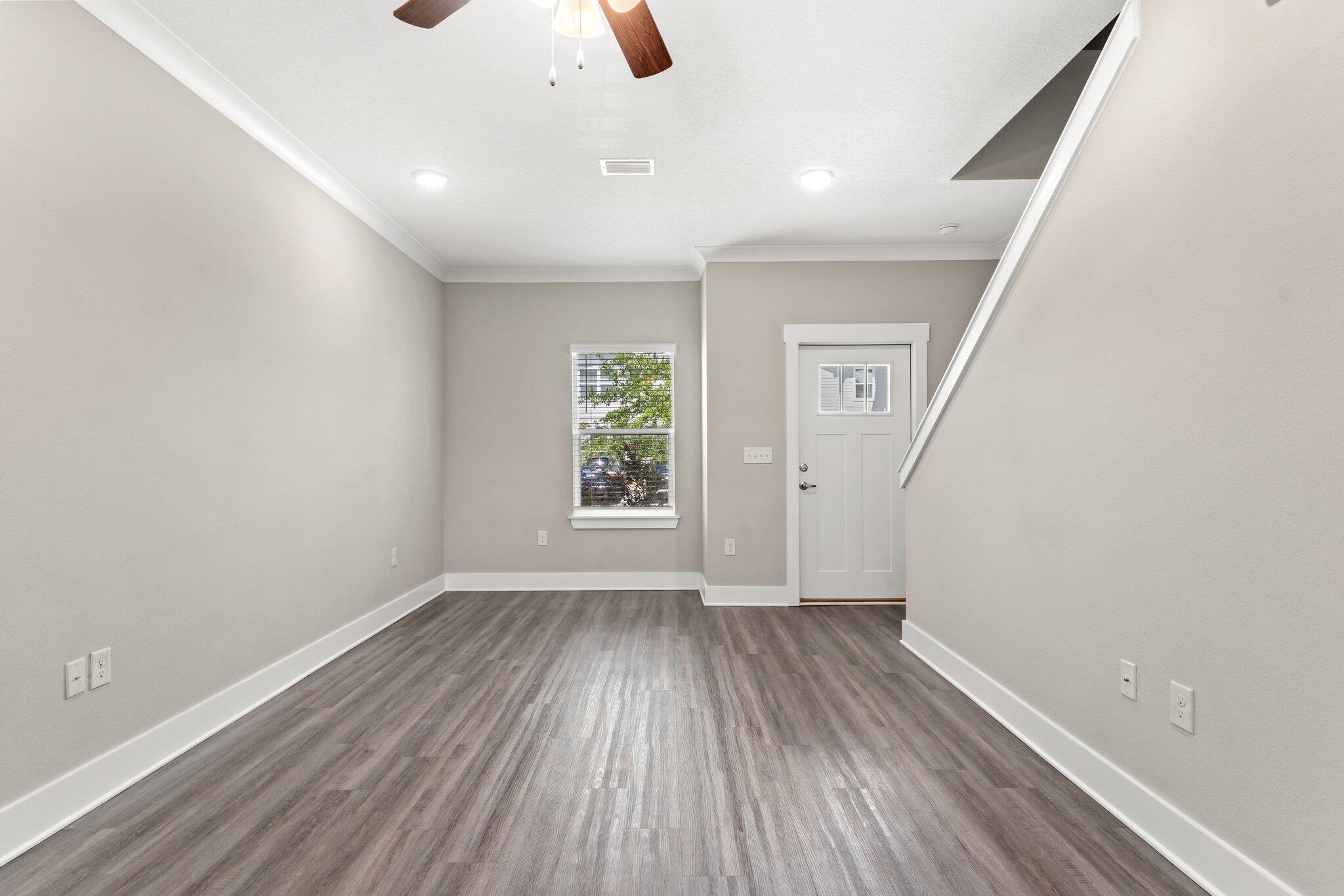 352 North Sand Palm Road, Unit VISTA Freeport, FL 32439 - Photo 5 of 29 an empty room with wooden floor and windows