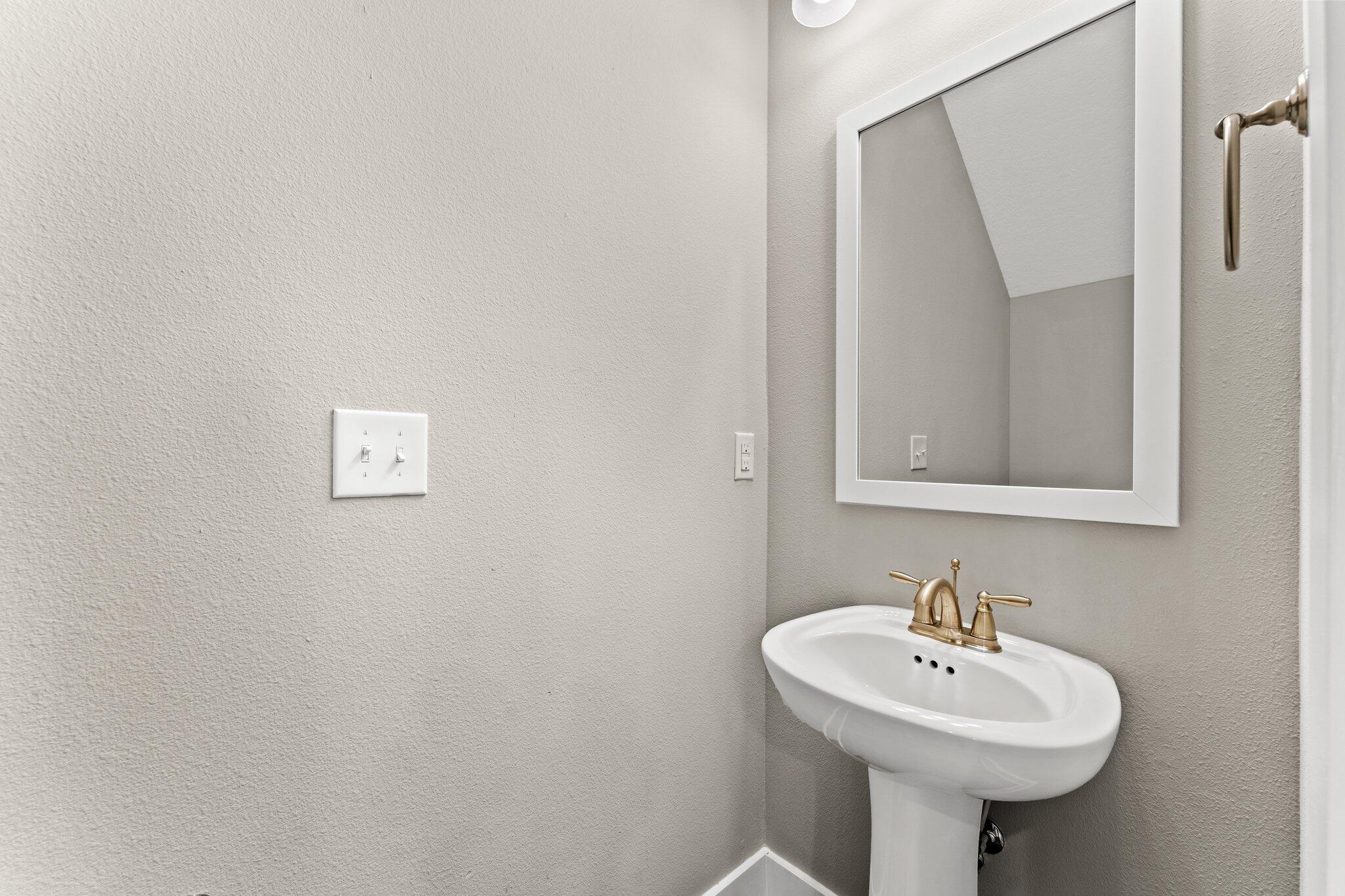 352 North Sand Palm Road, Unit VISTA Freeport, FL 32439 - Photo 7 of 29 a bathroom with a sink a mirror and a toilet