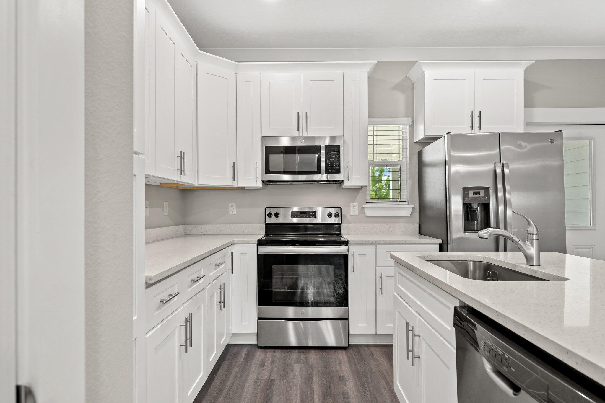 352 North Sand Palm Road, Unit VISTA Freeport, FL 32439 - Photo 10 of 29 a kitchen with stainless steel appliances granite countertop a stove a sink and a refrigerator