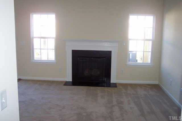 3539 Oneonta Avenue Raleigh, NC 27604 - Photo 3 of 10 an empty room with windows and fireplace