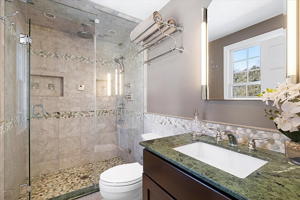 10 Spring Road Westborough, MA 01581 - Photo 21 of 42 a bathroom with a granite countertop sink a toilet a mirror and shower