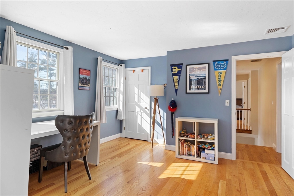 10 Spring Road Westborough, MA 01581 - Photo 26 of 42 a living room with furniture a dining table and a flat screen tv with wooden floor