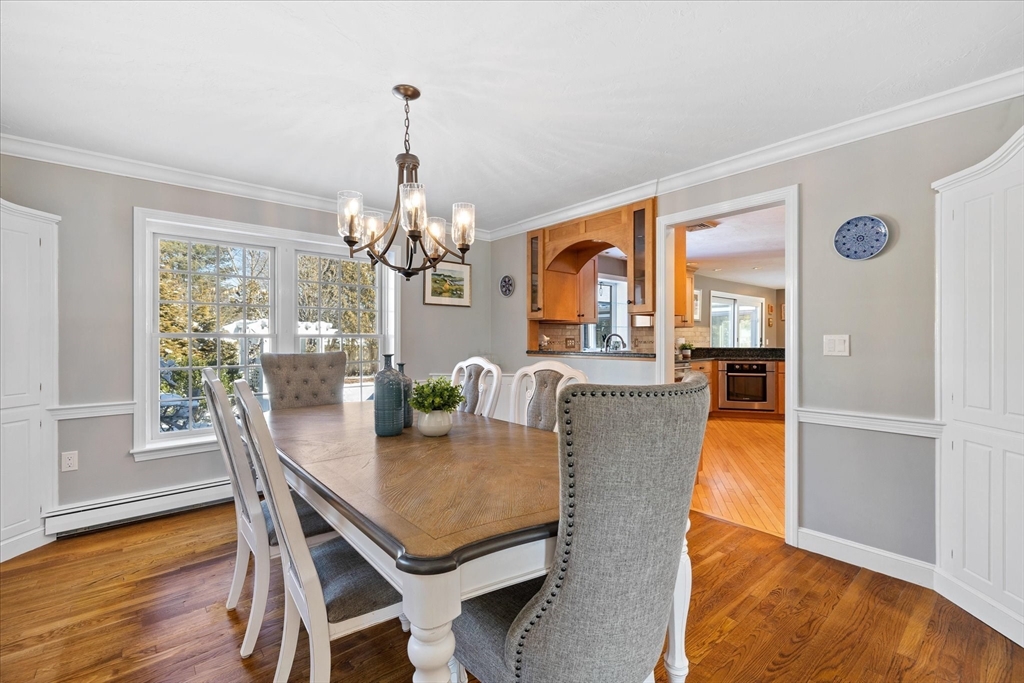 10 Spring Road Westborough, MA 01581 - Photo 6 of 42 a dining room with furniture a chandelier and wooden floor