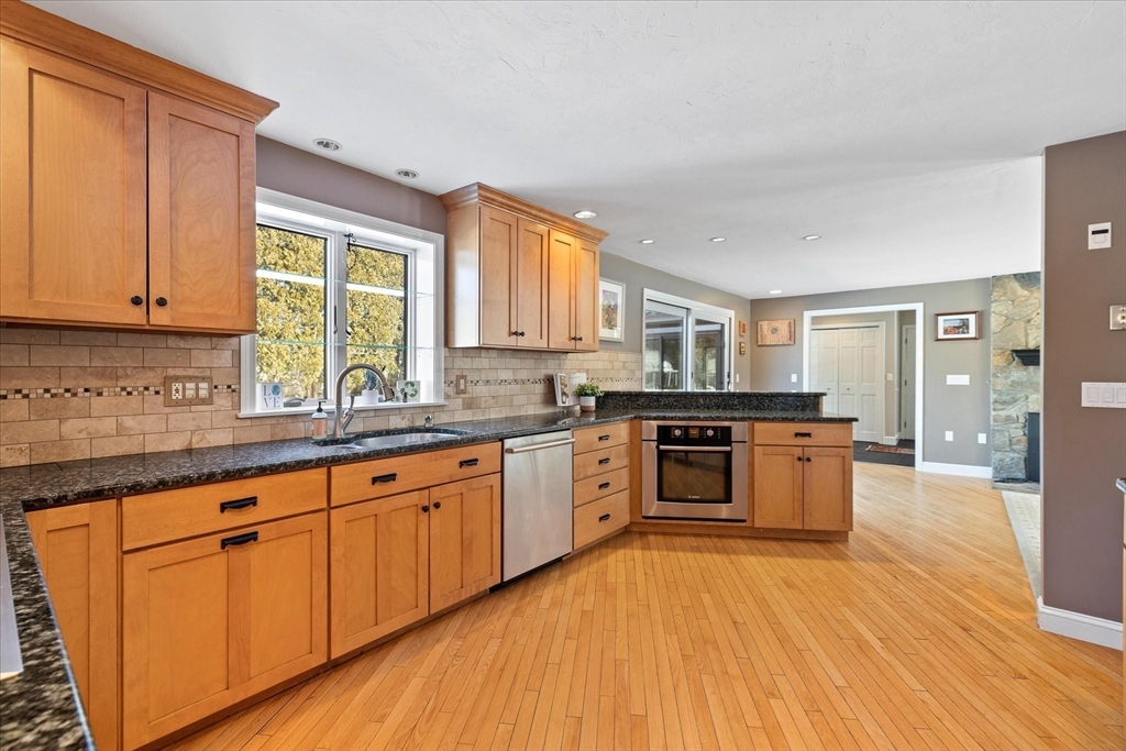 10 Spring Road Westborough, MA 01581 - Photo 8 of 42 a kitchen with stainless steel appliances granite countertop a stove a sink dishwasher and a refrigerator