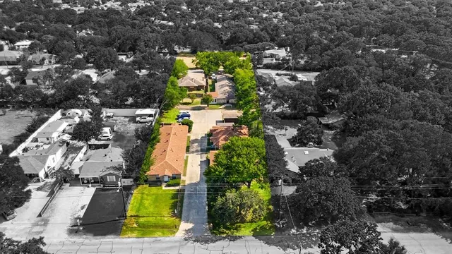 an aerial view of residential houses with outdoor space