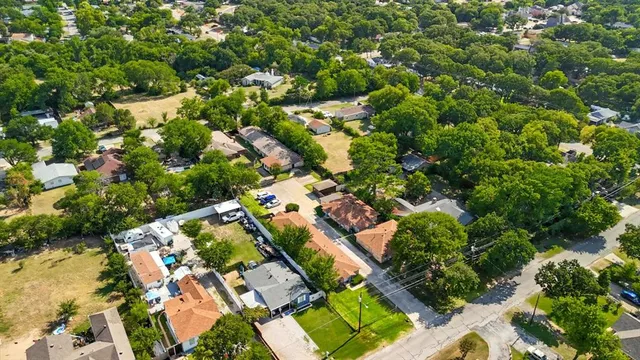 an aerial view of residential houses with outdoor space