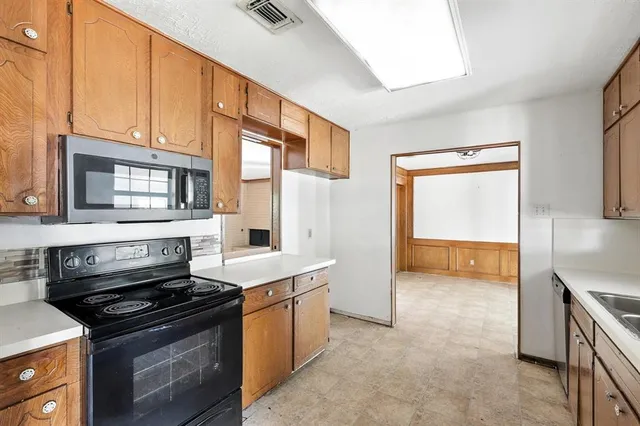 a kitchen with a stove and a microwave