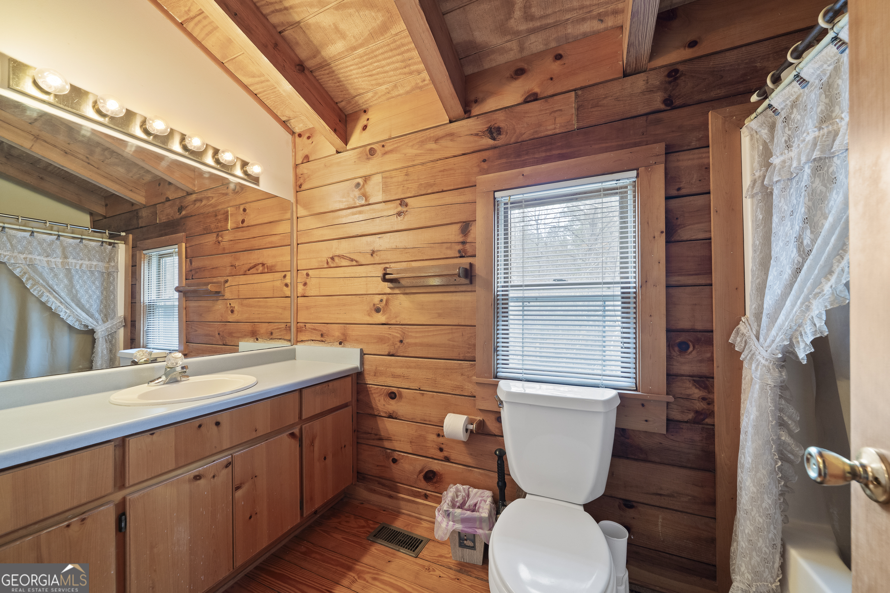 1011 Sandy Run Drive Sparta, GA 31087 - Photo 23 of 39 a bathroom with a toilet sink and mirror