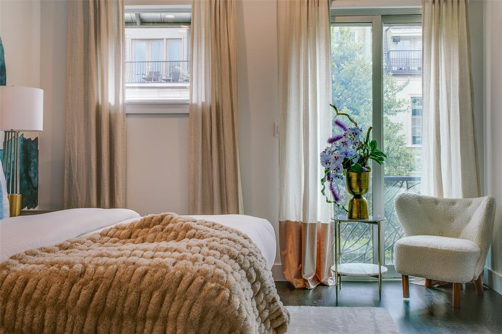 2211 Worthington Street Dallas, TX 75204 - Photo 23 of 36 a bedroom with a bed and a chair with the potted plant