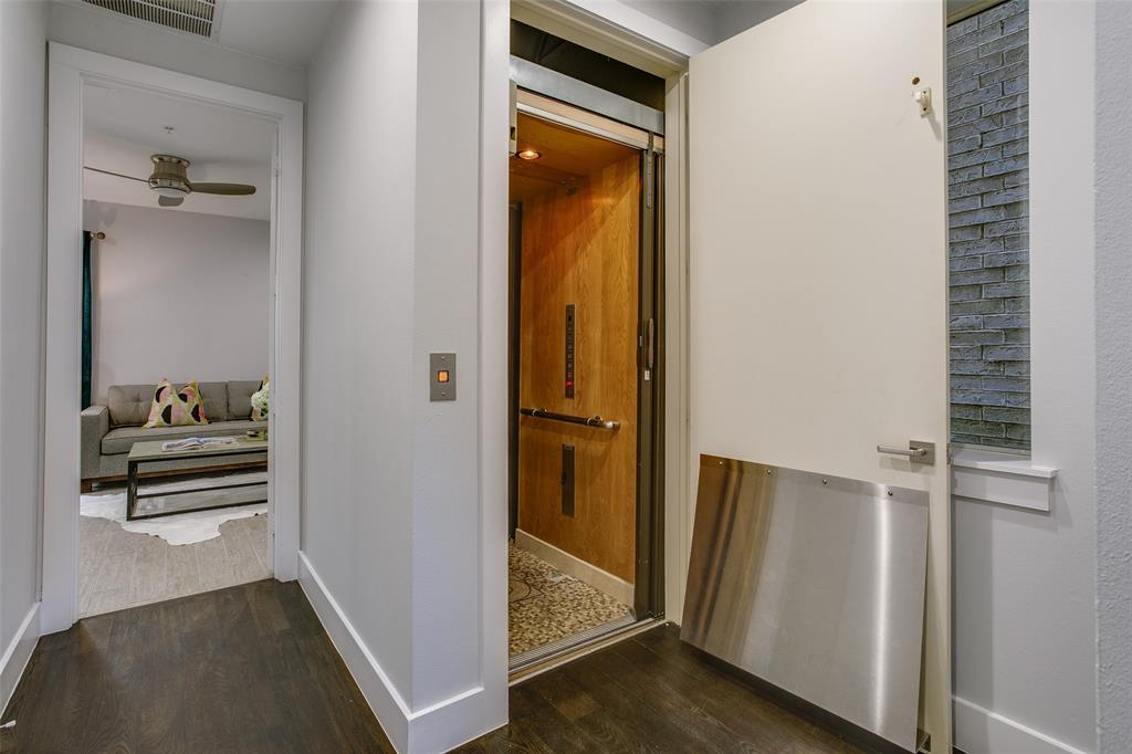2211 Worthington Street Dallas, TX 75204 - Photo 7 of 36 a view of a hallway with wooden floor and a bathroom