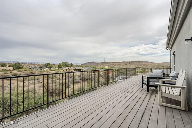 a view of roof deck with two couches and wooden floor