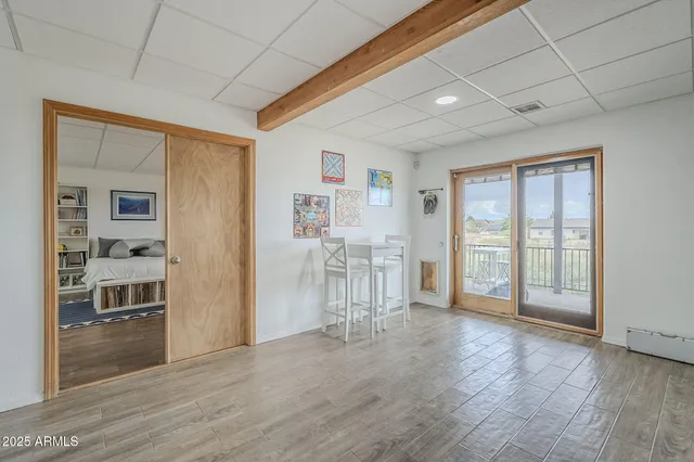 a view of empty room with wooden floor and cabinet