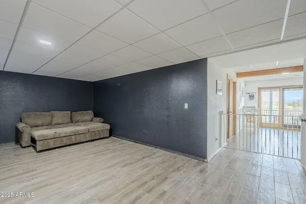 a living room with furniture and a ceiling fan