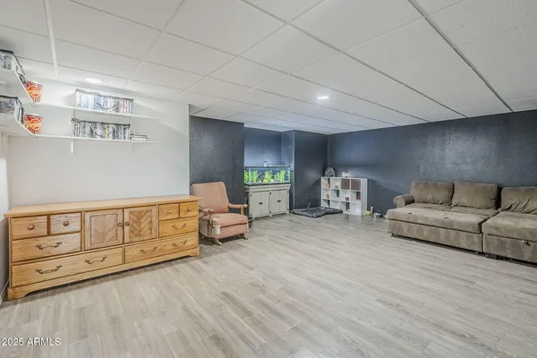 a living room with furniture and dresser