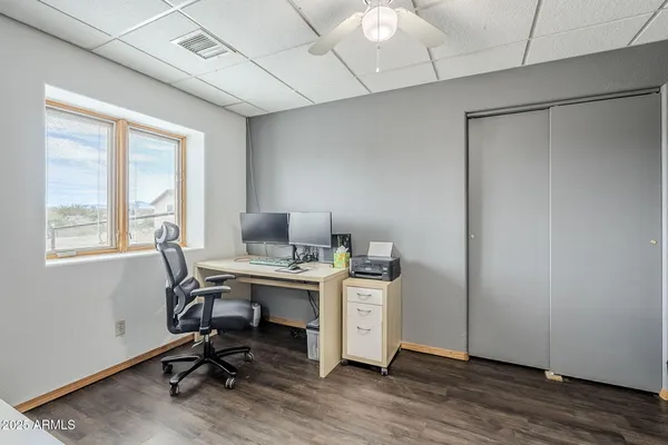 a view of a workspace with furniture and a window