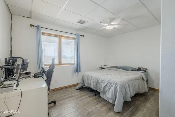 a bedroom with a bed a table and chair