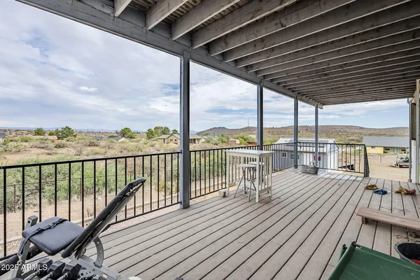 a view of a balcony with wooden floor