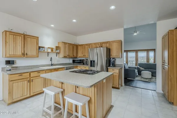 a kitchen with a stove a sink a counter top space and cabinets