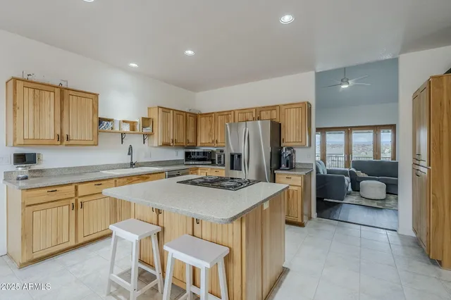 a kitchen with a stove a sink a counter top space and cabinets
