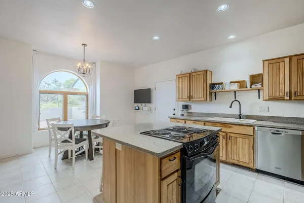 a kitchen that has a table and chairs in it