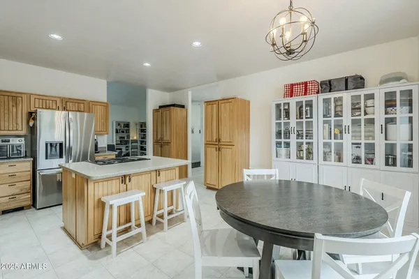 a kitchen with cabinets and refrigerator