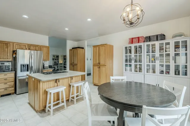a kitchen with cabinets and refrigerator