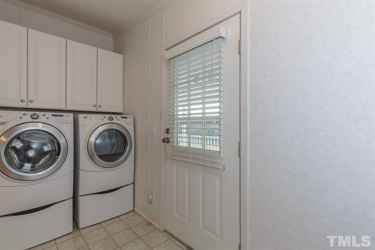 4959 Thom Road Mebane, NC 27302 - Photo 13 of 30 Spacious laundry room measures 12.5' x 5.2' with upper cabinets