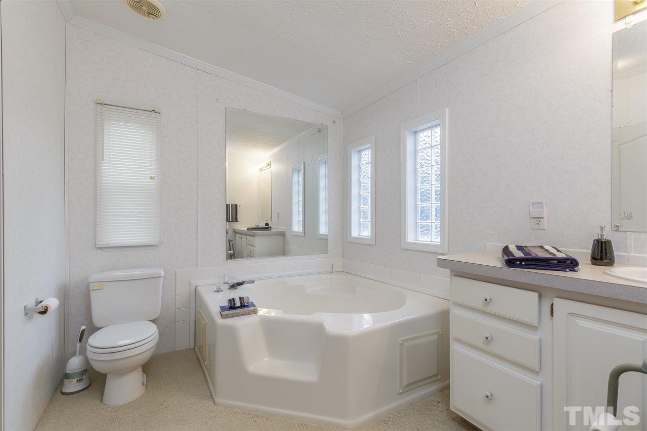 4959 Thom Road Mebane, NC 27302 - Photo 17 of 30 Master bath 1 provides garden tub, extended vanity and water closet
