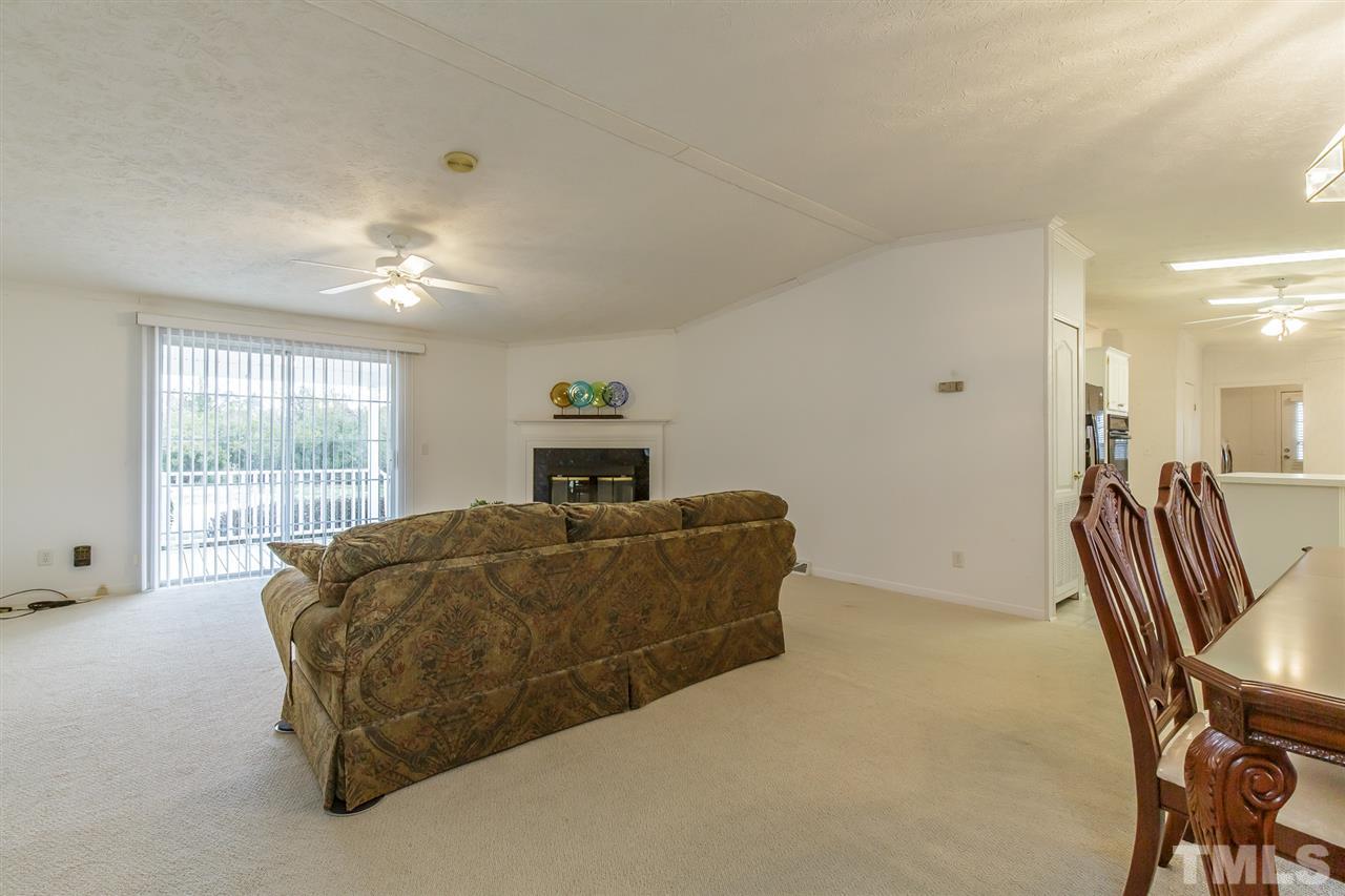 4959 Thom Road Mebane, NC 27302 - Photo 4 of 30 Family room boasts gaslog fireplace, fan, and door access to rear deck
