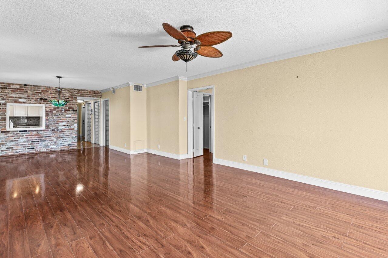 1040 Banyan Road, Unit 501C Boca Raton, FL 33432 - Photo 14 of 47 a view of a livingroom with wooden floor and a ceiling fan